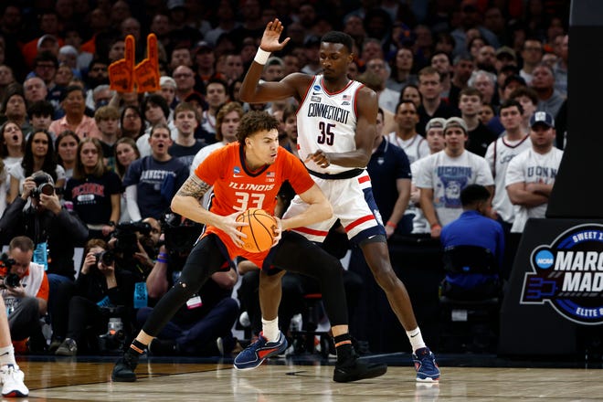 Mar 30, 2024; Boston, MA, USA; Illinois Fighting Illini forward Coleman Hawkins (33) dribbles the ball Connecticut Huskies forward Samson Johnson (35) in the finals of the East Regional of the 2024 NCAA Tournament at TD Garden. Mandatory Credit: Winslow Townson-USA TODAY Sports