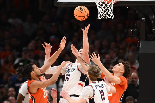 Mar 30, 2024; Boston, MA, USA;Connecticut Huskies center Donovan Clingan (32) grabs a rebound against the Illinois Fighting Illini in the finals of the East Regional of the 2024 NCAA Tournament at TD Garden. Mandatory Credit: Brian Fluharty-USA TODAY Sports