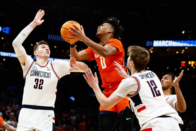 Mar 30, 2024; Boston, MA, USA;Illinois Fighting Illini guard Terrence Shannon Jr. (0) shoots the ball against Connecticut Huskies center Donovan Clingan (32) in the finals of the East Regional of the 2024 NCAA Tournament at TD Garden. Mandatory Credit: Winslow Townson-USA TODAY Sports