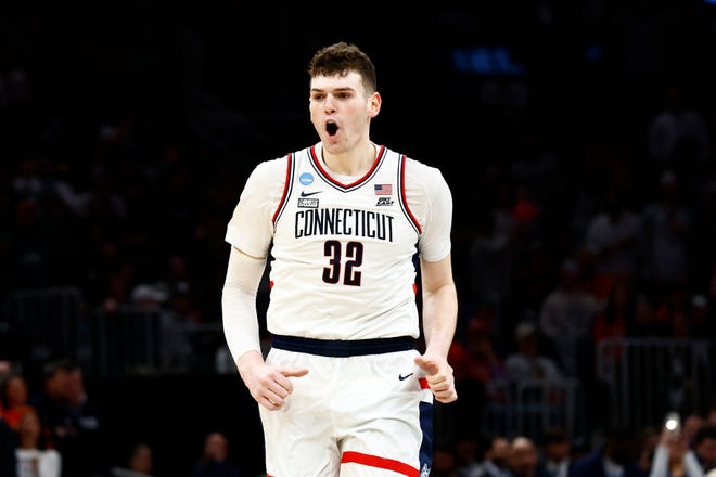 Mar 30, 2024; Boston, MA, USA; Connecticut Huskies center Donovan Clingan (32) reacts against the Illinois Fighting Illini in the finals of the East Regional of the 2024 NCAA Tournament at TD Garden. Mandatory Credit: Winslow Townson-USA TODAY Sports