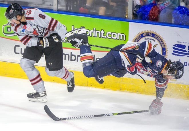 Peoria's Chase Spencer gets airborne as he tangles with Huntsville's Doug Elgstam in the first period of the deciding game of the SPHL President's Cup finals Sunday, April 28, 2024 at the Peoria Civic Center.