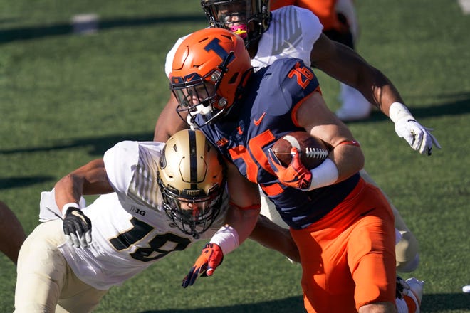 Illinois running back Mike Epstein (26) carries the ball as Purdue cornerback Cam Allen defends during the first half of an NCAA college football game Saturday, Oct. 31, 2020, in Champaign, Ill. (AP Photo/Charles Rex Arbogast)