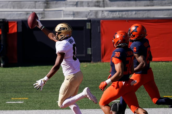 Purdue wide receiver Milton Wright, left, celebrate his touchdown reception as Illinois defensive back Sydney Brown (30) and Nate Hobbs watch during the first half of an NCAA college football game Saturday, Oct. 31, 2020, in Champaign, Ill. (AP Photo/Charles Rex Arbogast)