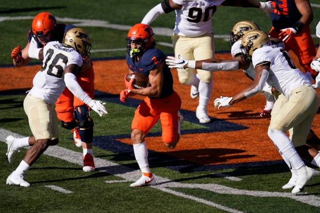 Illinois running back Chase Brown (2) carries the ball during the first half of an NCAA college football game against Purdue Saturday, Oct. 31, 2020, in Champaign, Ill. (AP Photo/Charles Rex Arbogast)