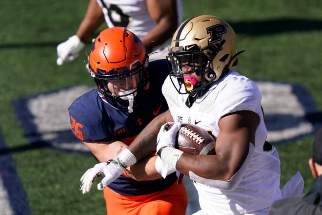 Purdue linebacker Derrick Barnes advances his interception of a pass by Illinois quarterback Coran Taylor, as running back Mike Epstein defends during the first half of an NCAA college football game Saturday, Oct. 31, 2020, in Champaign, Ill. (AP Photo/Charles Rex Arbogast)