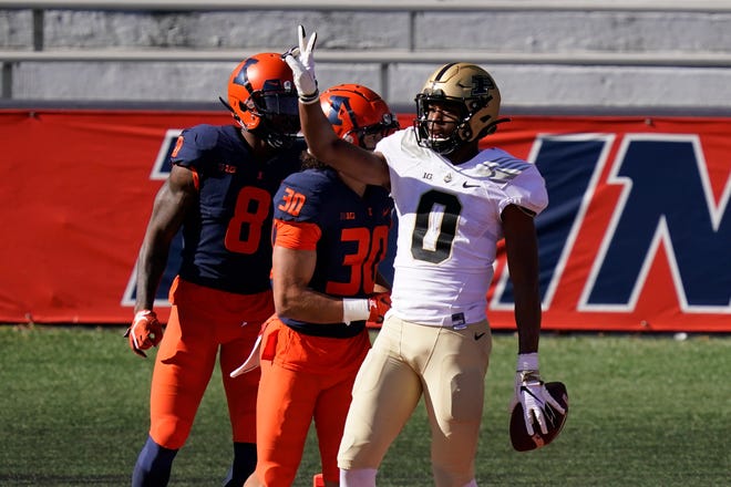 Purdue wide receiver Milton Wright, right, celebrates his touchdown reception as Illinois defensive back Sydney Brown (30) and Nate Hobbs watch during the first half of an NCAA college football game Saturday, Oct. 31, 2020, in Champaign, Ill. (AP Photo/Charles Rex Arbogast)