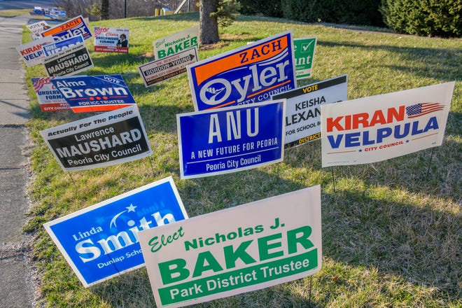 Dozens of campaign signs fill an embankment near the Peoria County Election Commission on Brandywine Drive in Peoria.